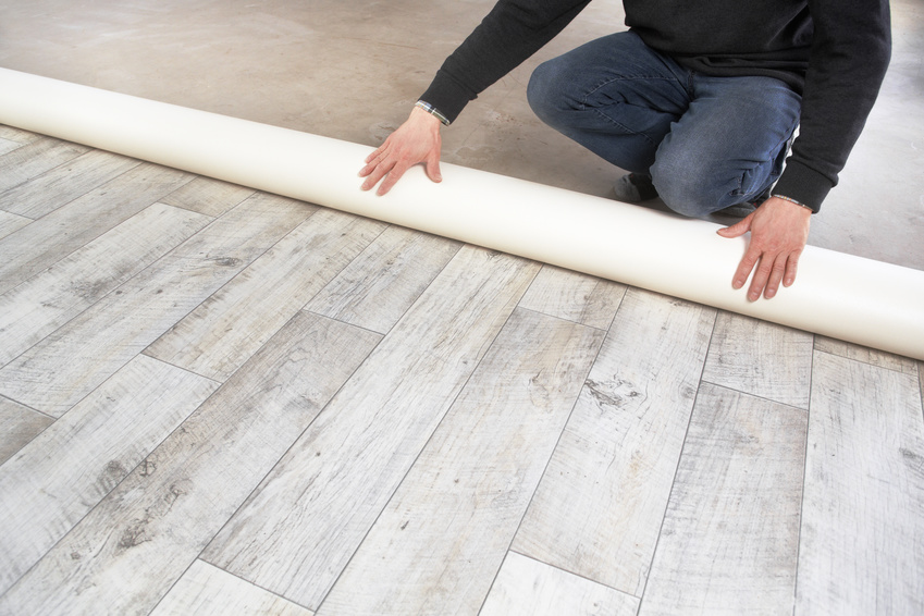 rolling out a PVC flooring